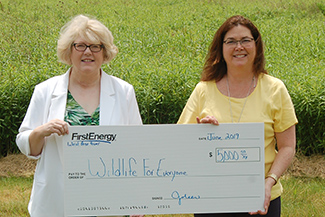 Image of Susan Hawthorne of Wildlife for Everyone and Joleen Hindman of First Energy holding a check for $5000
